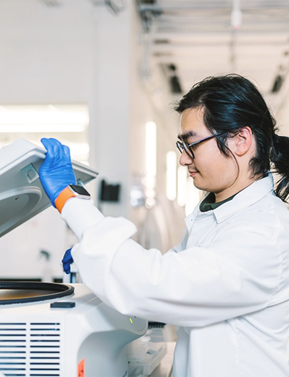 Kymera lab employee operates equipment